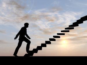 Concept conceptual 3D male businessman on stair or steps over sunset sky background, metaphor to success, climb, business, rise, achievement, growth, job, career, leadership, education, goal or future